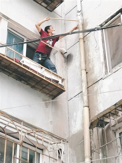 爬花台 接水管 社区干部修好漏水 居民安度雨夜