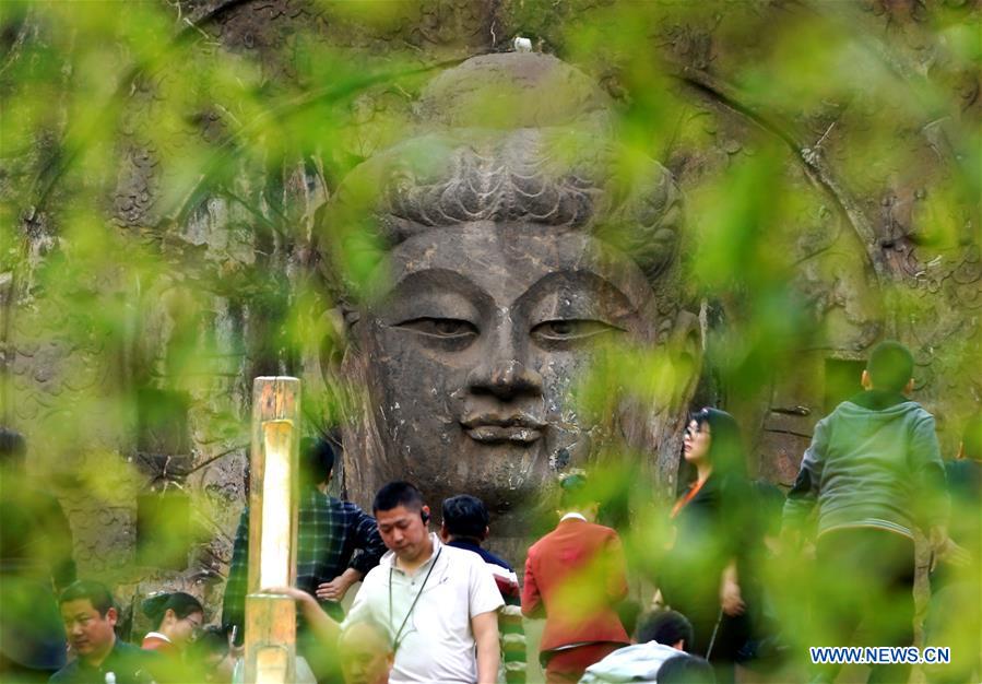 People visit Longmen Grottoes scenic area in Luoyang, C China's Henan