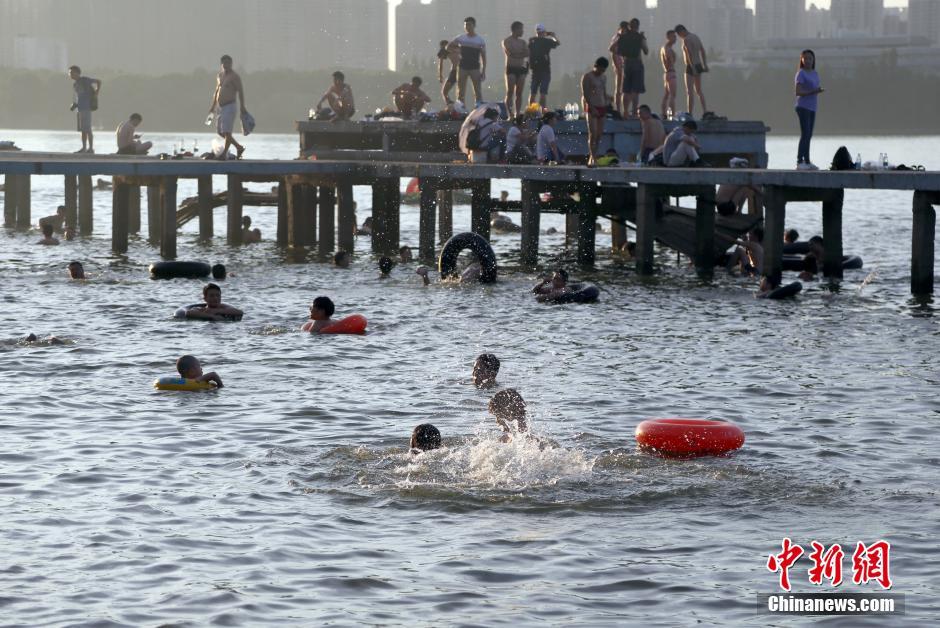 武汉连续多日高温酷暑 东湖游泳点挤满避暑市民