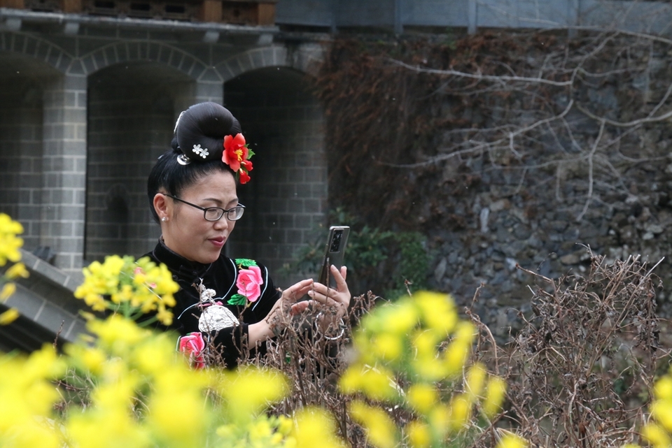 贵州雷山郎德苗寨：油菜花盛景催生“花经济”_fororder_图为游客在旅拍3.JPG